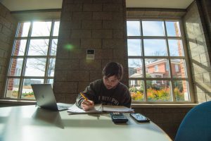 student studying alone at a table